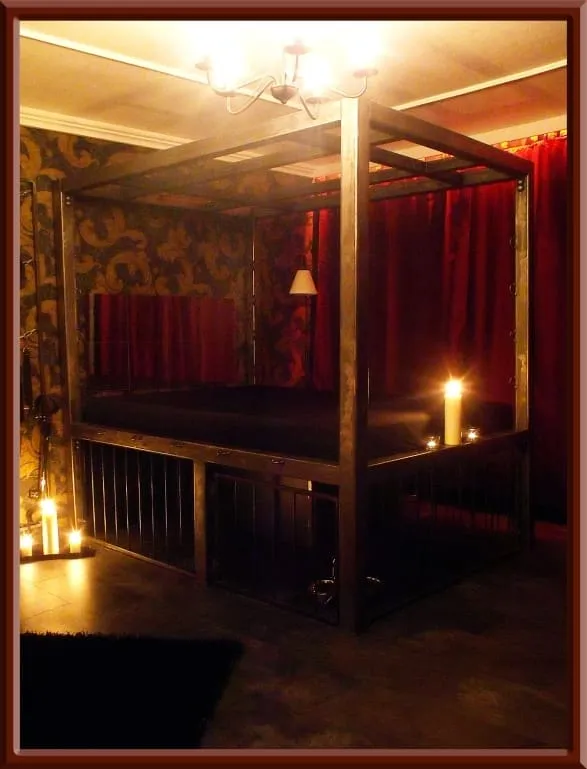 Bed with a bondage frame and candles