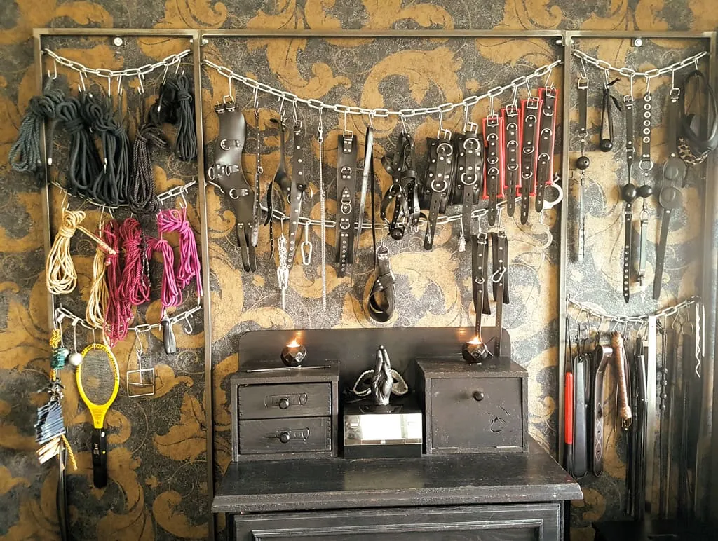 Wall of toys and restraint equipment